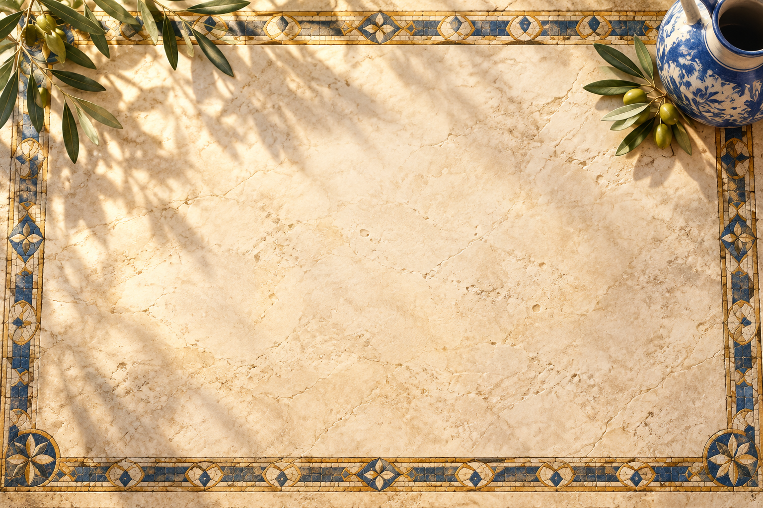The What Remains limestone table with olive leaves, a blue ceramic pitcher, and a blue-and-gold mosaic border